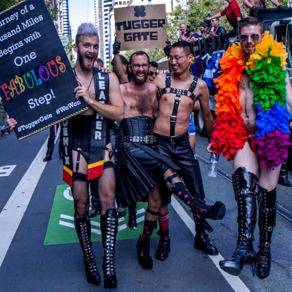 group of glbtqi people celebrating, while wearing leather as an outfit